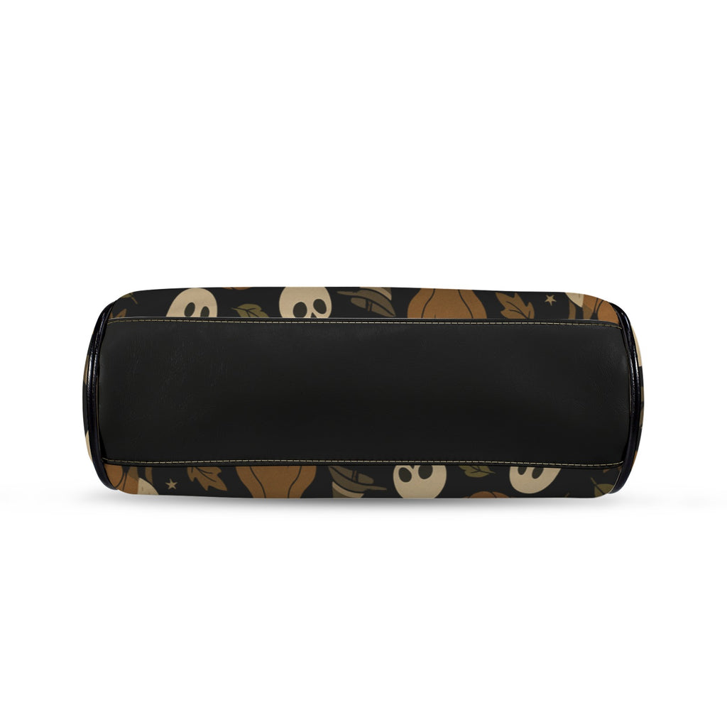 Underside of kisslock bag with autumn ghosts, pumpkins, and woodland animal print and black bottom panel