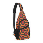 Opposite three-quarter view of chest bag with burnt-orange and red Haunted Hotel geometric print and shoulder strap