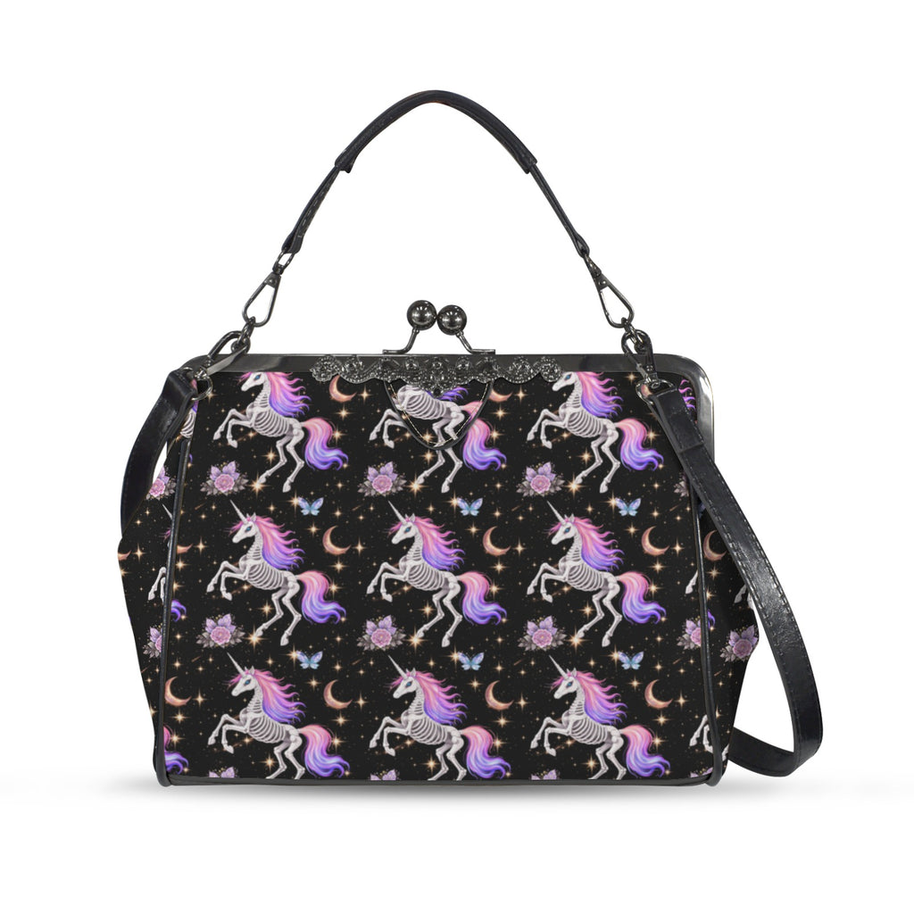 Kisslock crossbody bag with skeleton unicorns with purple and pink manes on black, front view with handle and shoulder strap