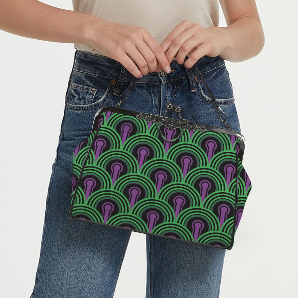 Model carrying kisslock bag with green arches and purple keyhole pattern by the top handle