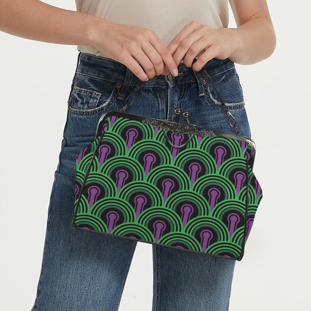 Model carrying kisslock bag with green arches and purple keyhole pattern by the top handle