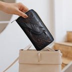 Black Crow Wallet being placed inside a handbag