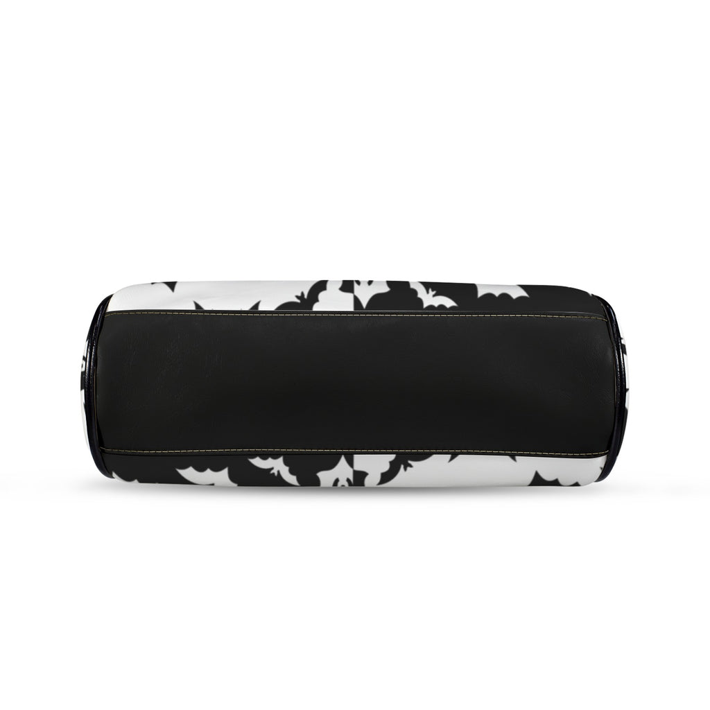 Underside of kisslock bag with black and white bat pattern and black bottom panel