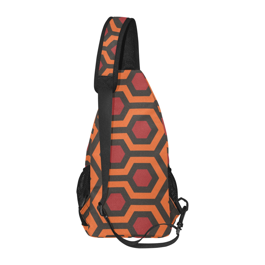 Side profile of chest bag with burnt-orange and red Haunted Hotel geometric print and adjustable shoulder strap