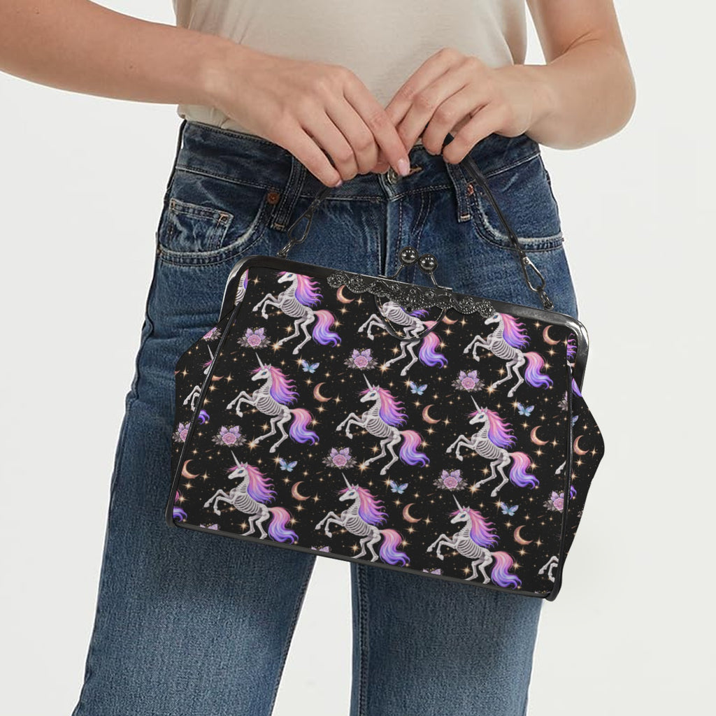 Model carrying kisslock bag with skeleton unicorns with purple and pink manes on black by the top handle