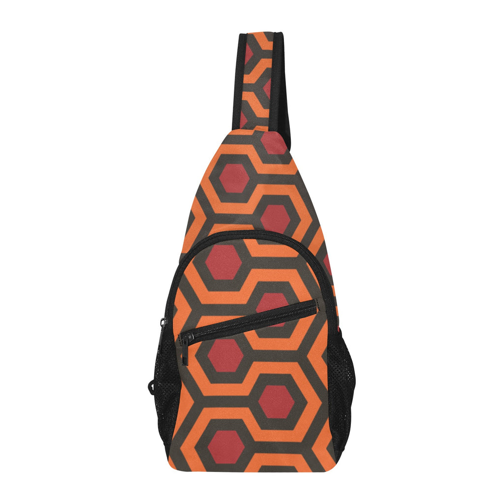 Chest bag with burnt-orange and red Haunted Hotel geometric print, upright view showing zippered front pocket