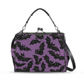 Kisslock crossbody bag with purple and black bat pattern, front view with handle and shoulder strap