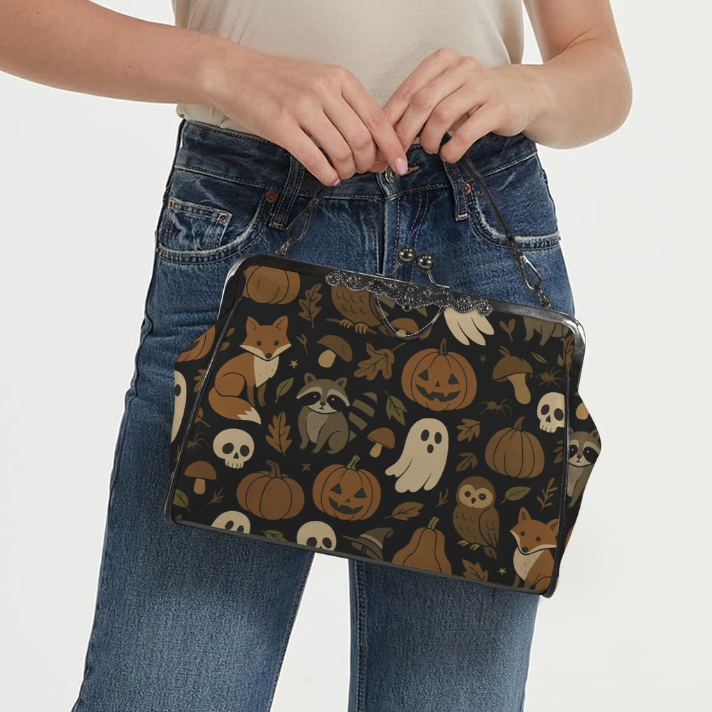 Model carrying kisslock bag with autumn ghosts, pumpkins, and woodland animal print by the top handle